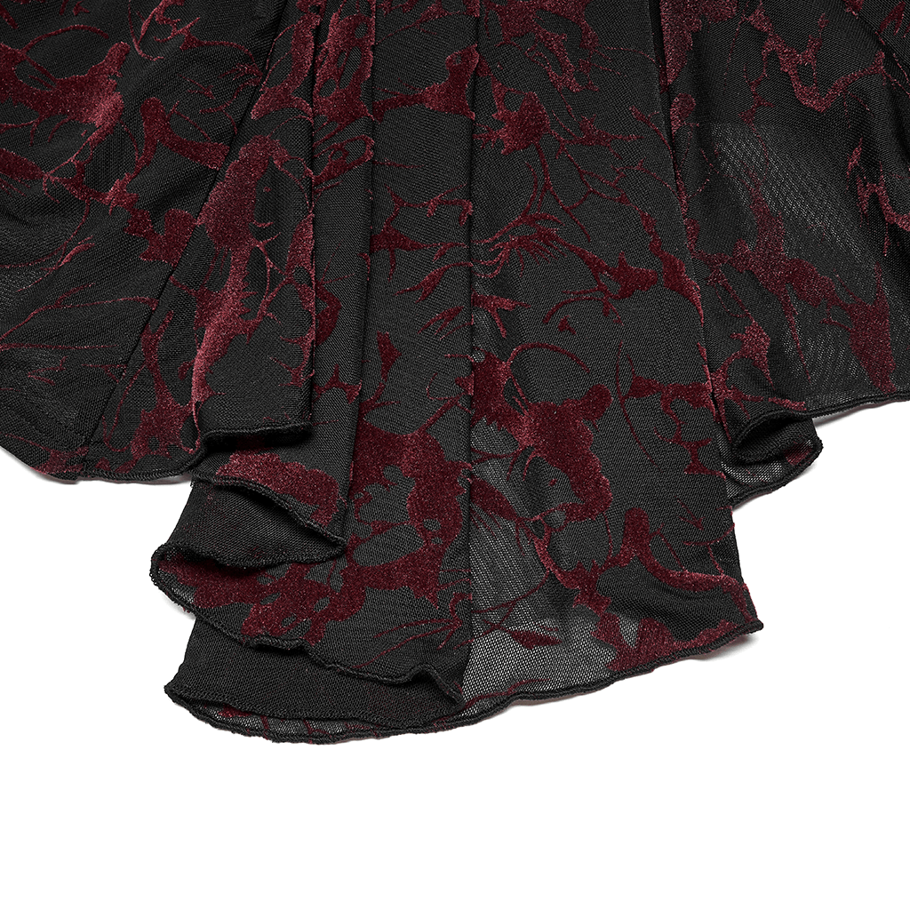 Scarlet abstract mesh fabric detail of a gothic V-neck top, showcasing elegant flared cuffs and intricate design.