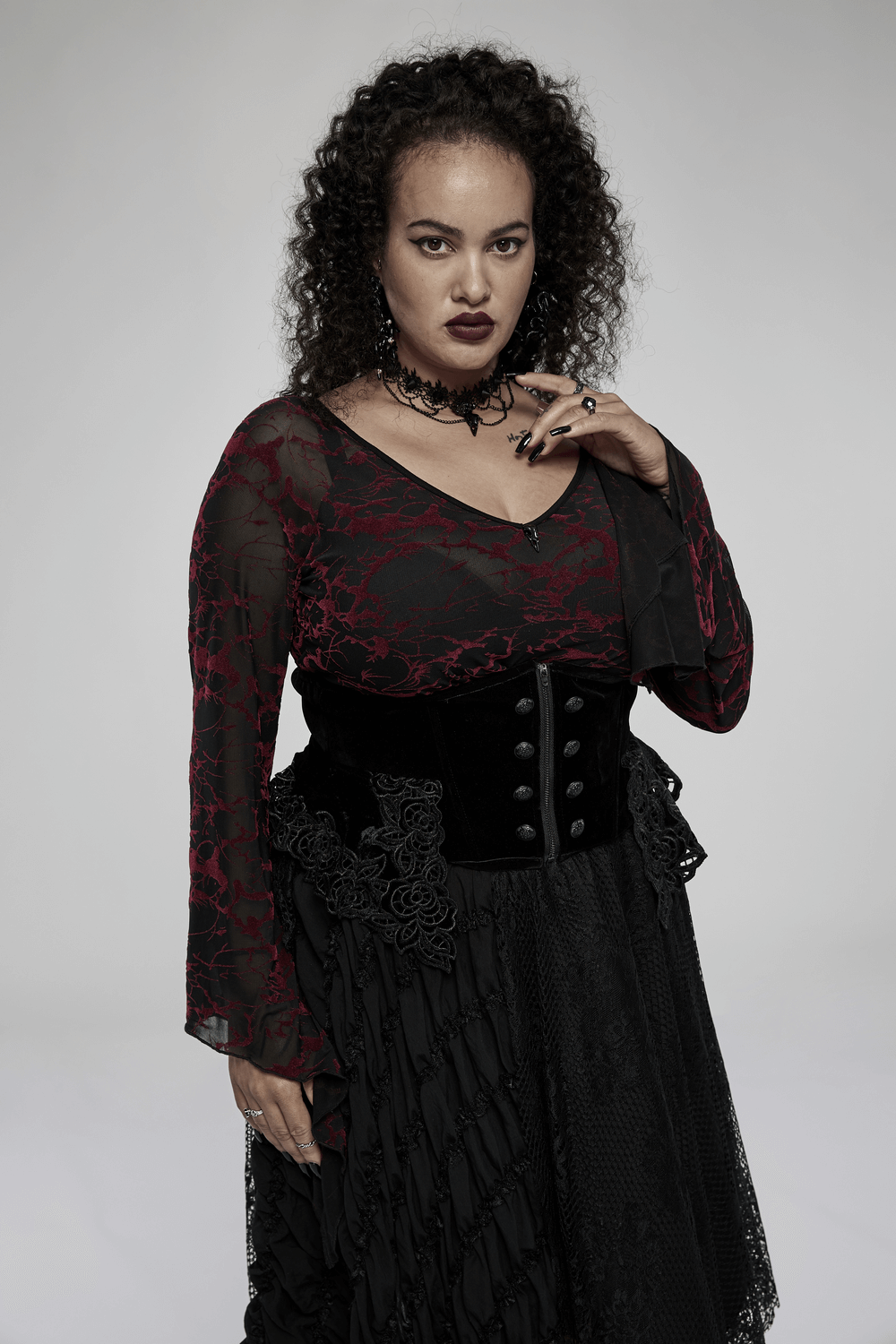 Scarlet abstract V-neck mesh top for women styled with gothic accessories and layered skirt.