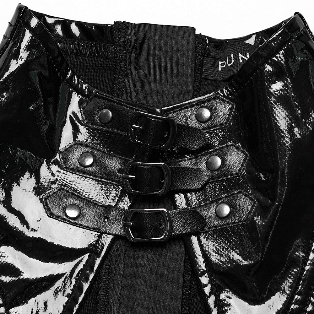 Close-up of glossy black faux leather dress detail with thick metal zippers and stylish buttons for a punk look.