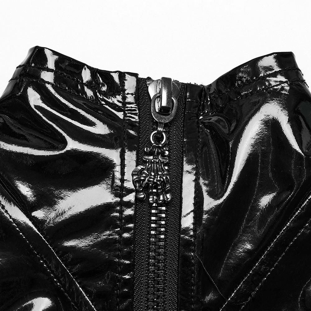 Close-up of glossy black faux leather dress showcasing thick metal zipper with unique engraved button detail.