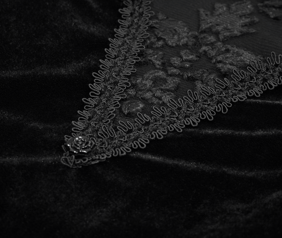 Close-up of black velvet dress with lace insert and floral embroidery, perfect for a gothic style outfit.