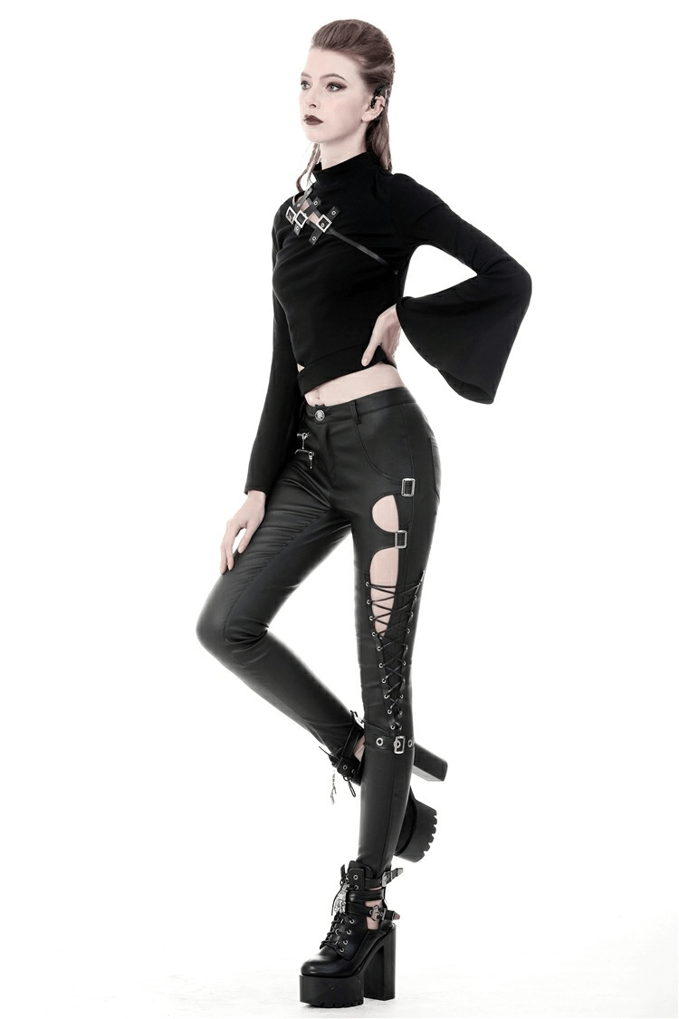 Fierce goth fashion: model in sexy asymmetrical skinny pants with cutouts and lace-up detailing.
