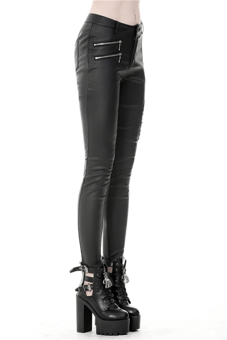 Fierce black skinny pants with side cutouts and lace-up details, styled with bold platform boots.