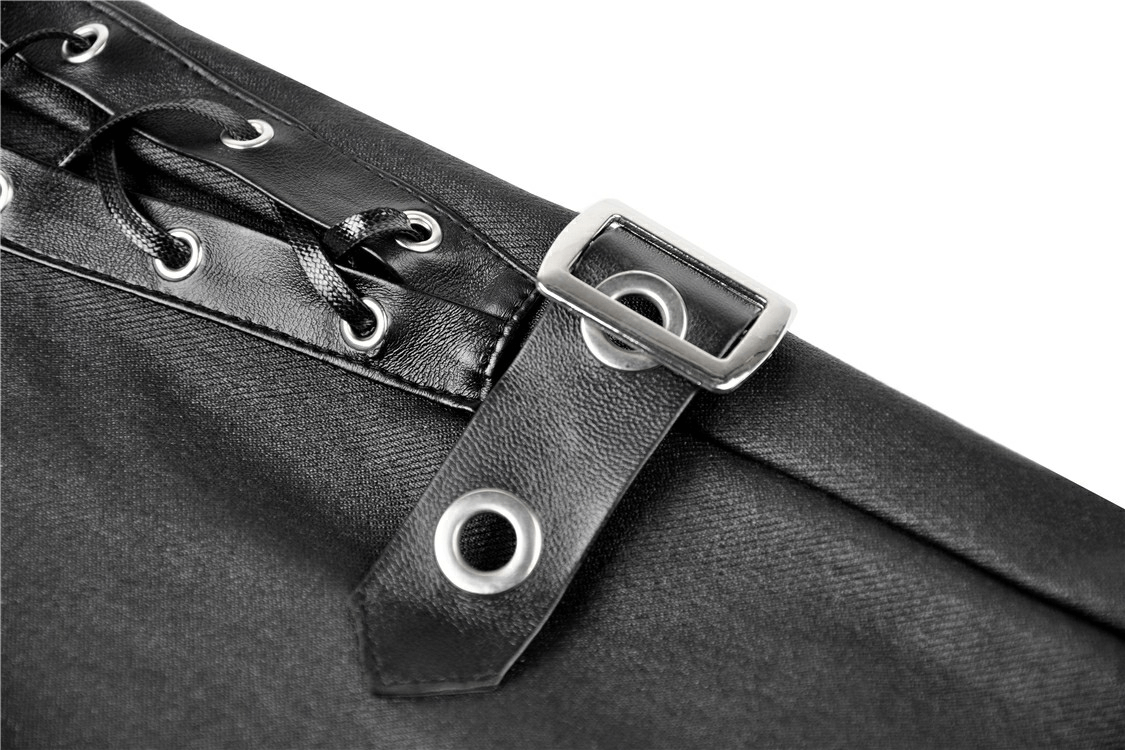 Close-up of black skinny pants showcasing lace-up detailing and metal hasp closure for a punk fashion statement.