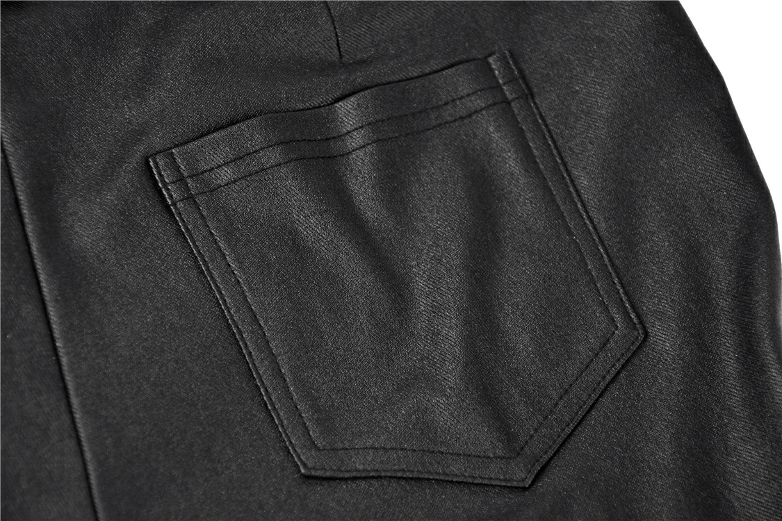Close-up of the back pocket detail on sexy asymmetrical skinny pants in black fabric.