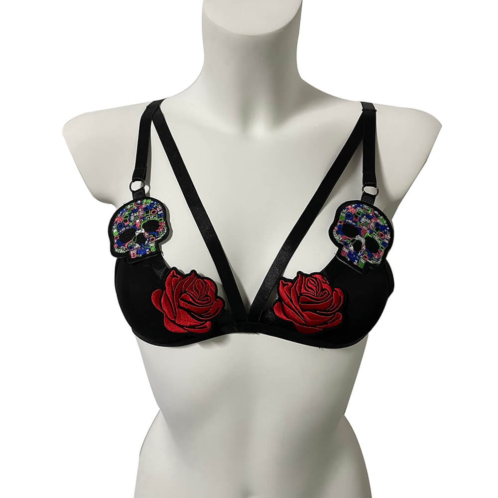 Seductive black bra with red roses and colorful skull embellishments, perfect for bold and risqué fashion.