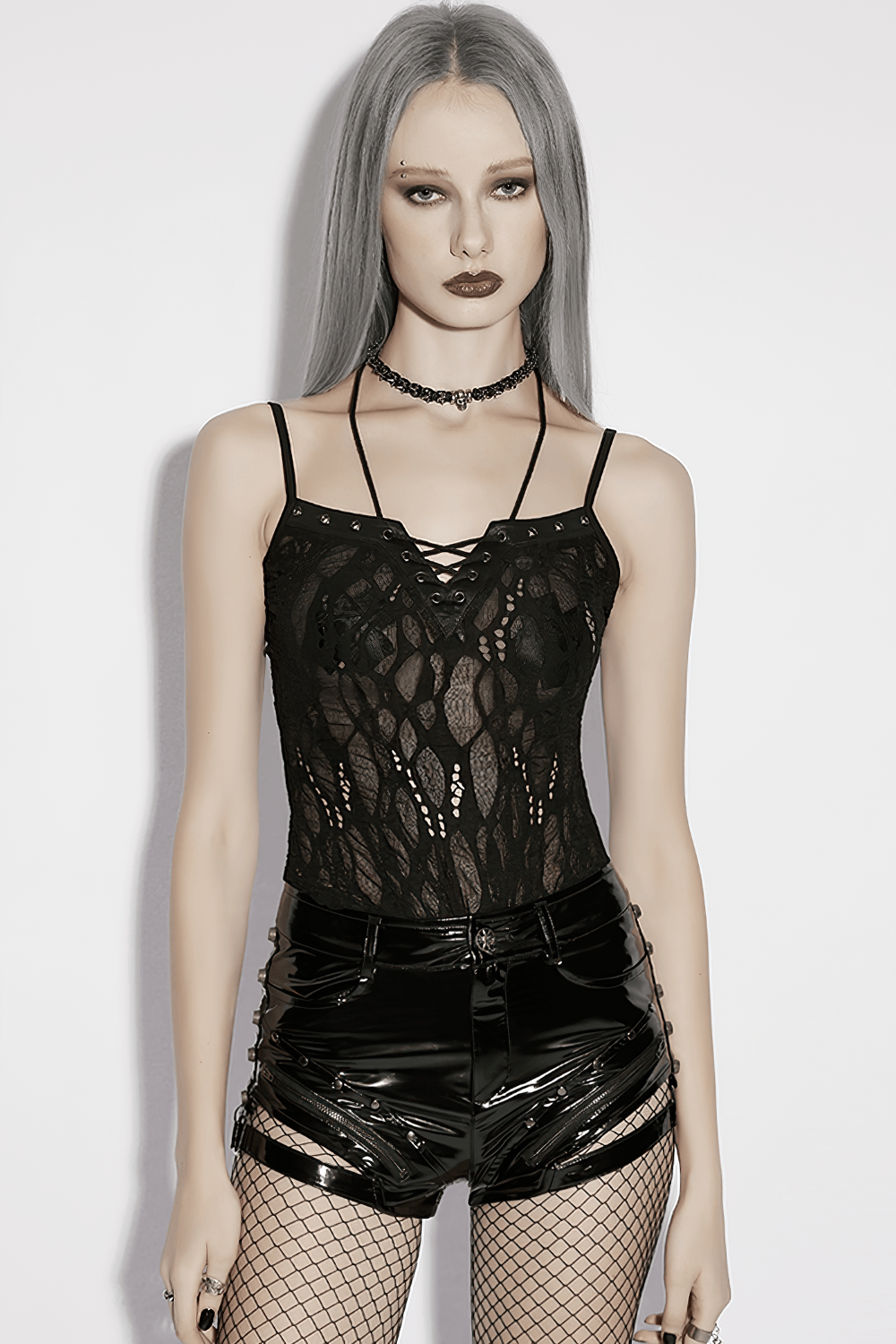 Alt Tag: Sexy Black Gothic Lace Mesh Lace-Up Punk Camisole on model with sheer lace mesh, lace-up V neckline, vinyl shorts, fishnets