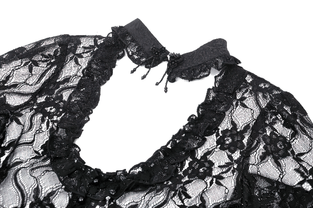 Close-up of a sexy black lace top with intricate designs and elegant bell sleeves, ideal for gothic evening wear.