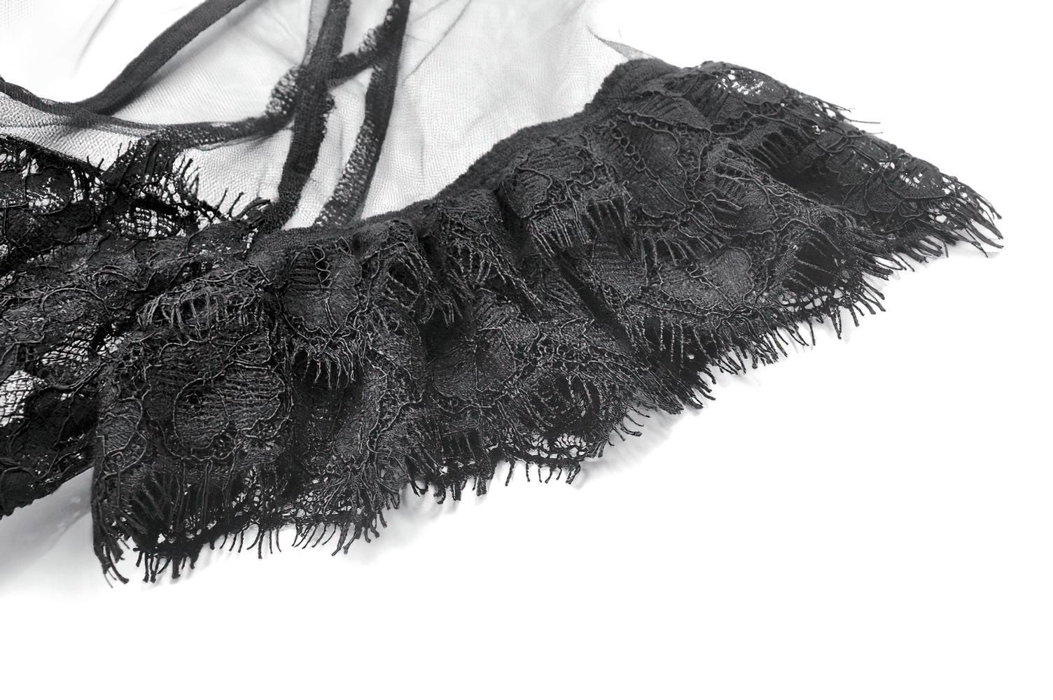 Close-up of delicate black lace trim on a gothic tulle dress, showcasing intricate patterns and elegant style.