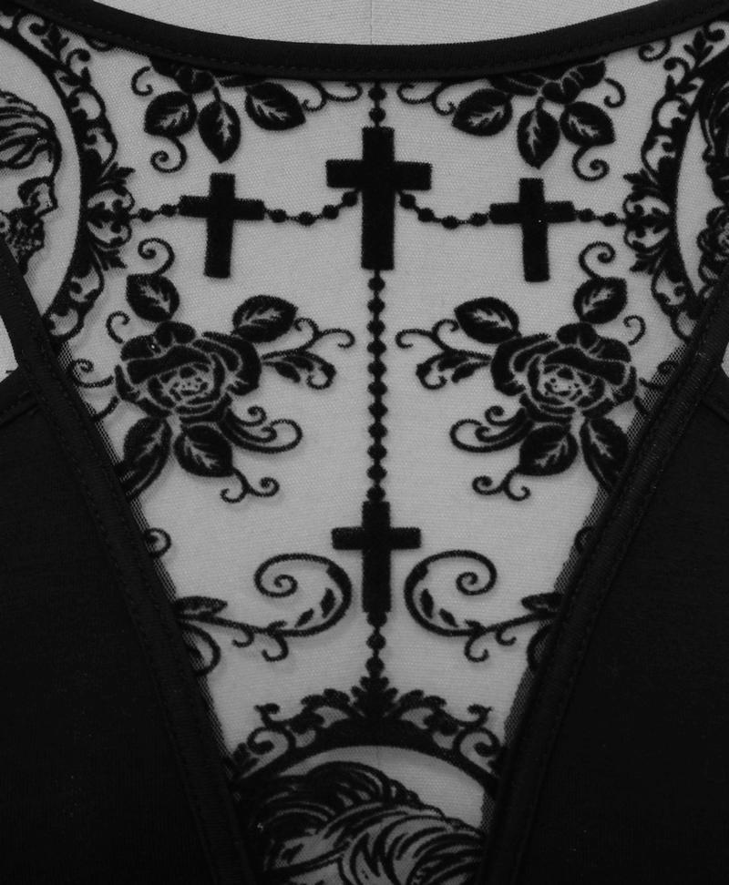 Detailed view of black vintage dress featuring gothic rose and cross lace pattern on a sheer neckline.