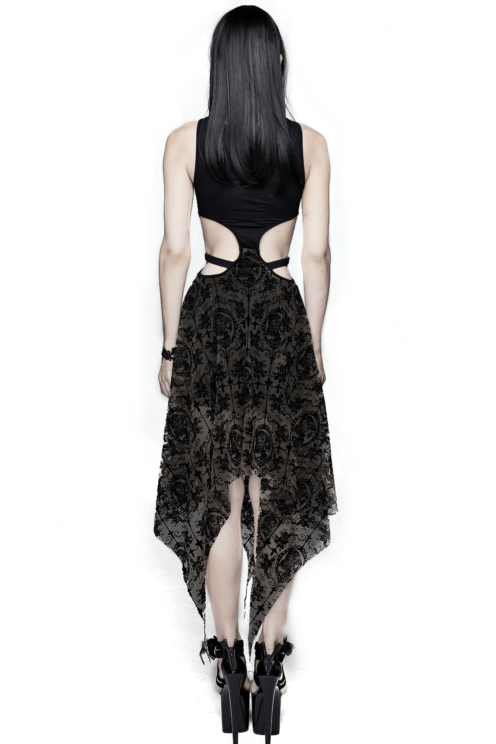 Back view of a gothic women's black vintage dress with asymmetrical cut and metal heart straps.