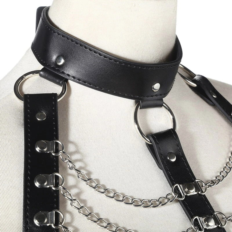Close-up of a women's black leather chest harness with zinc alloy chains in Gothic fashion.