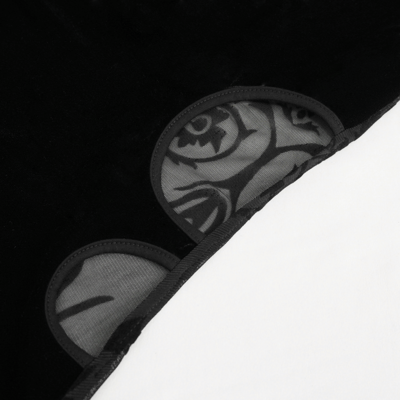 Close-up of black velvet fabric with mesh floral details, showcasing a blend of texture and elegance.