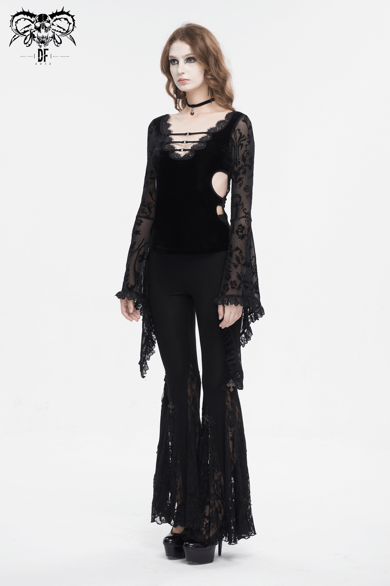 Woman in a sexy deep v-neck lace top with flared sleeves, showcasing a vintage floral pattern and stylish pants.