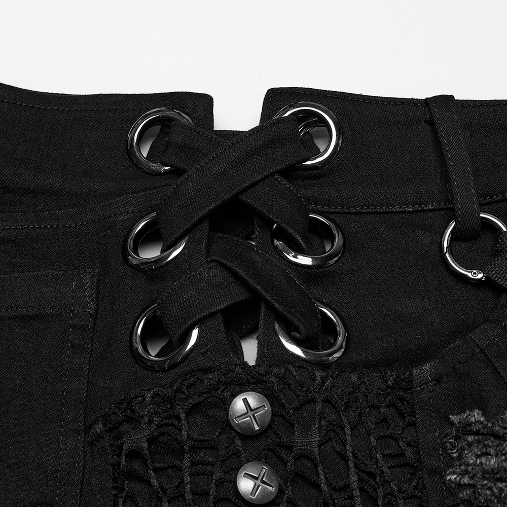 Close-up of punk-style black denim shorts with metal eyelets and lace-up detail for an edgy look.