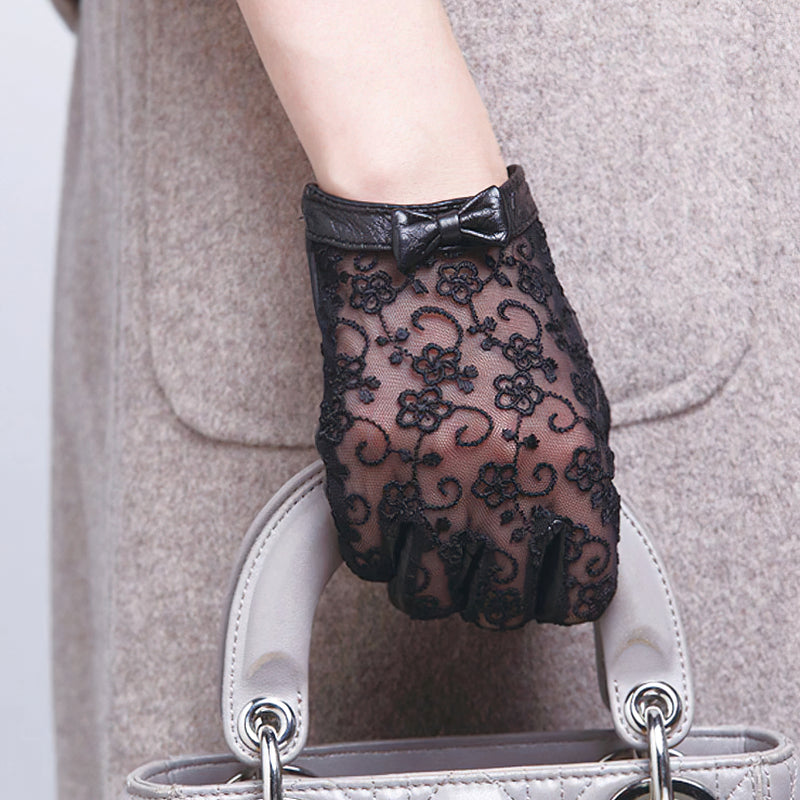 Elegant women's black lace gloves with bow detail, perfect for vintage fashion outfits and special occasions.