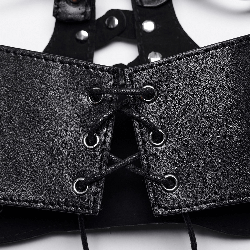 Close-up of black faux leather straps with eyelets and laces from a gothic bustier top, showcasing edgy punk style.