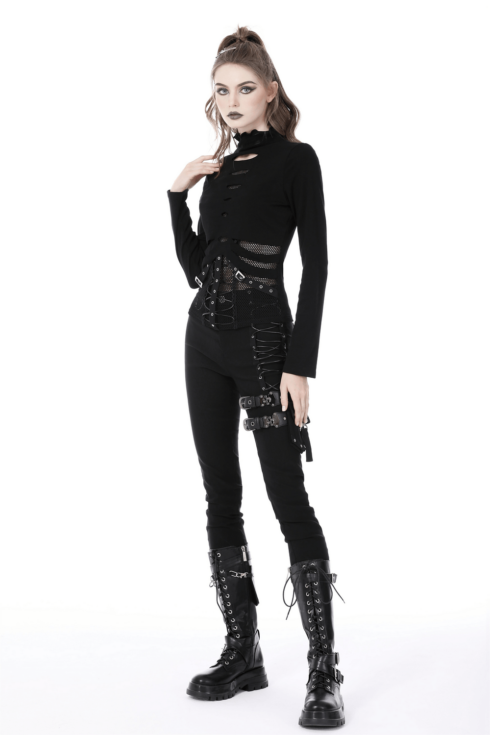 Stylish model in a sexy black fishnet sweatshirt with edgy hardware, paired with skinny pants and lace-up boots.