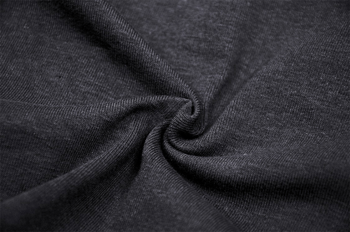 Close-up of soft black fabric showcasing a unique texture, perfect for stylish mesh sweatshirts.