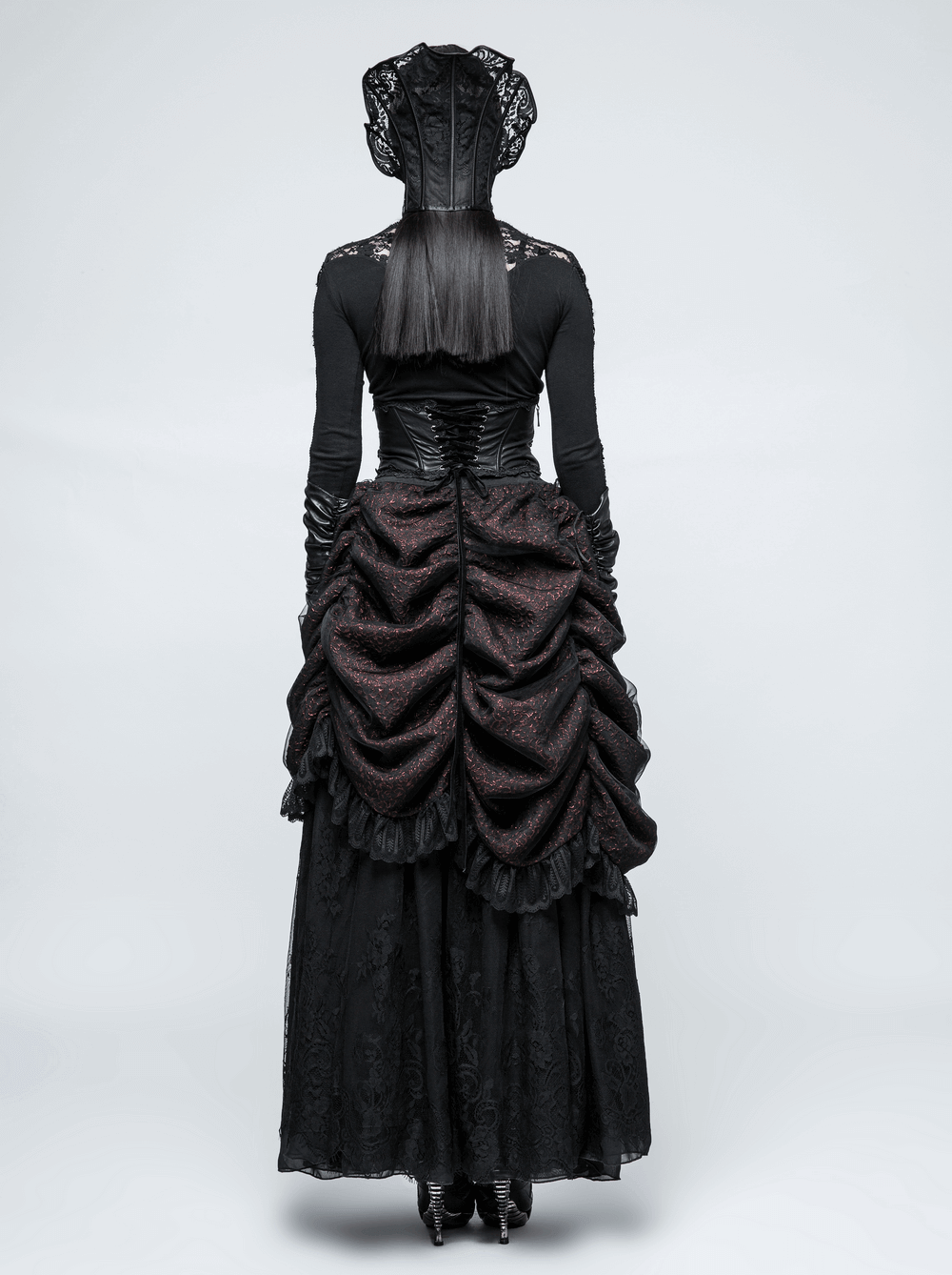 Elegant black Victorian dress with ruffled skirt and lace details, showcases a dramatic back view.