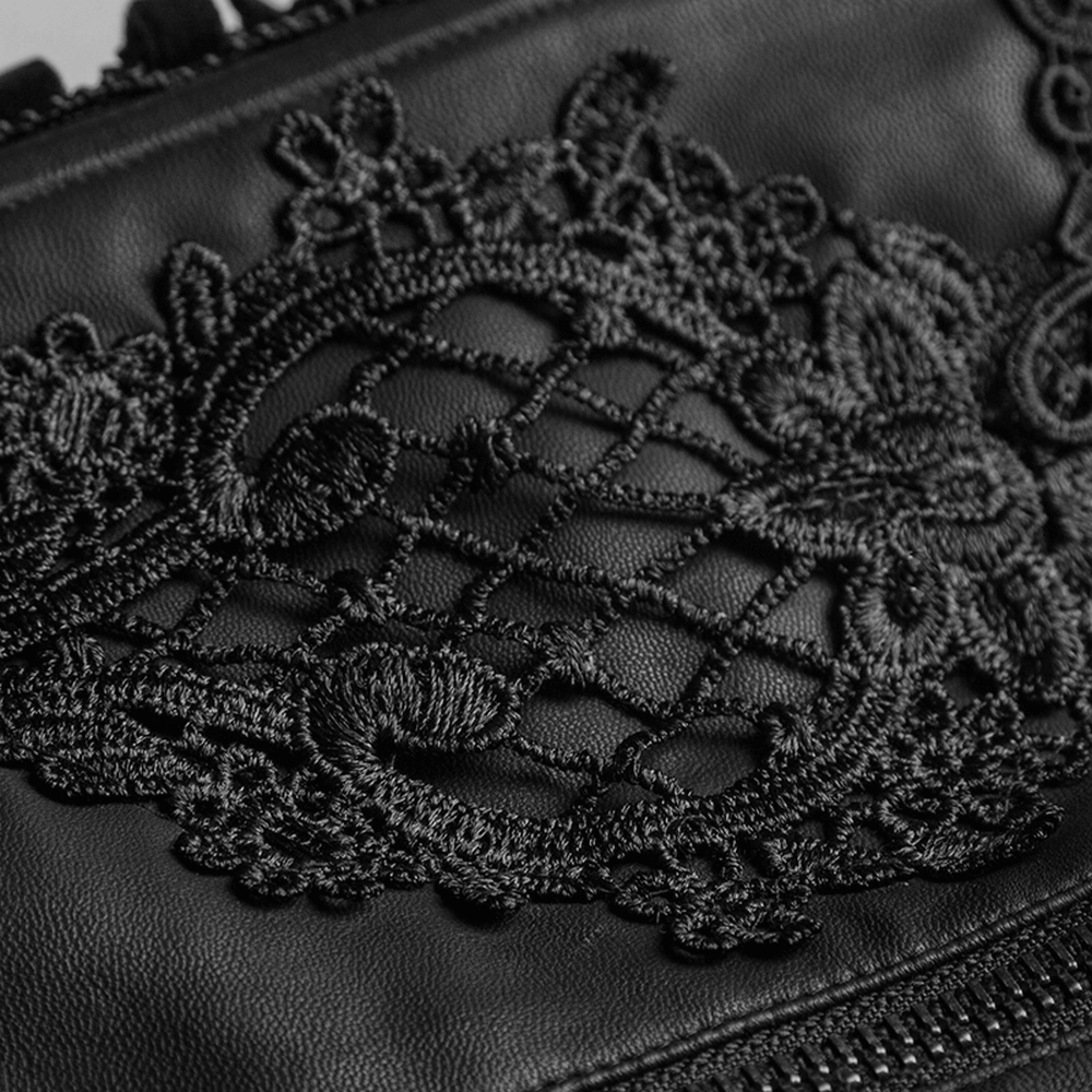 Close-up of intricate black floral embroidery on a leather corset, showcasing detailed Victorian design.