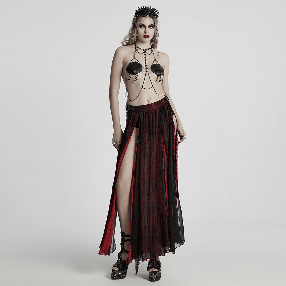 Gothic dark shell chain bra with beads, paired with a flowing red and black skirt, showcasing bold fashion elegance.