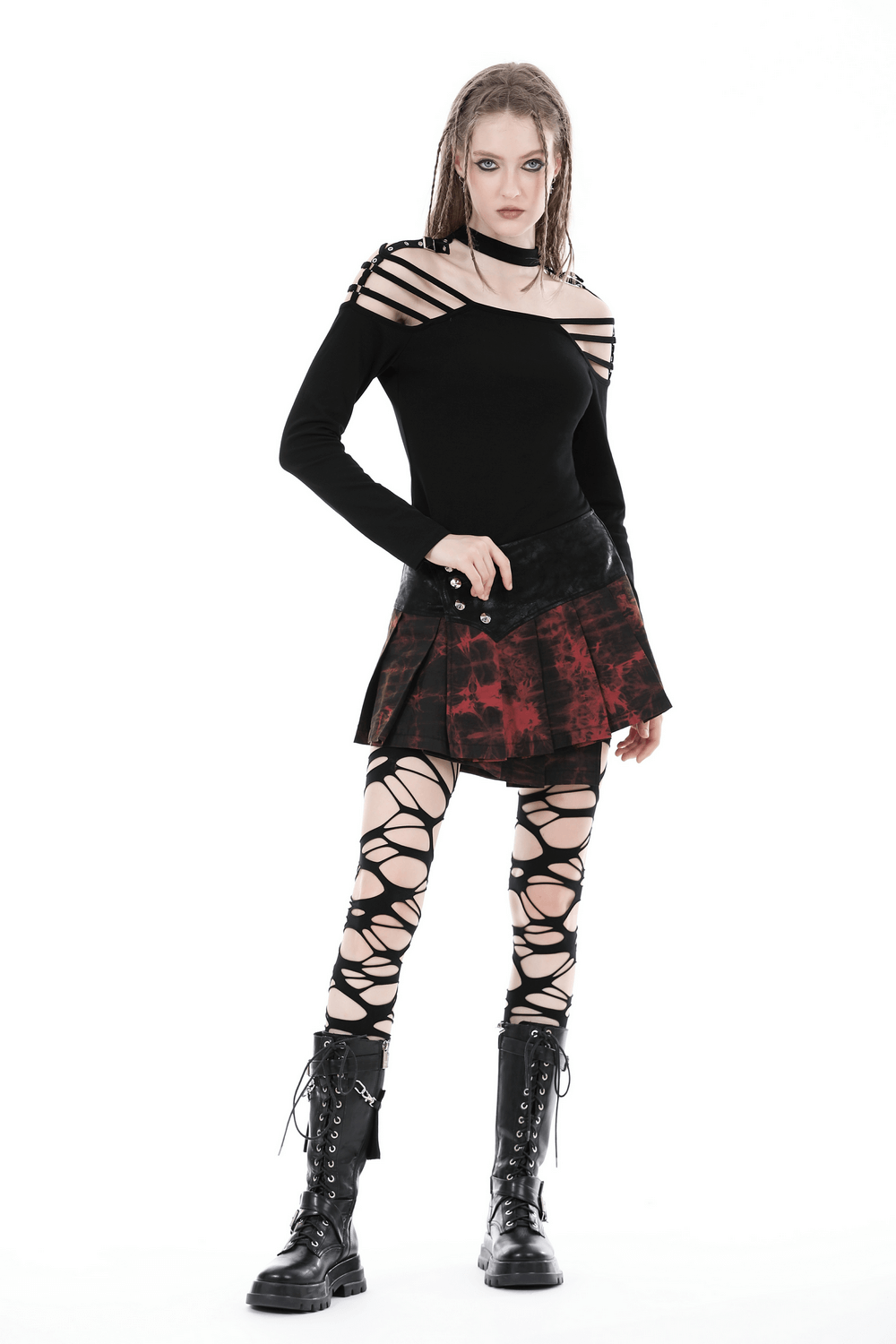 Model wearing a sexy gothic off-shoulder top with long sleeves, styled with a plaid skirt and lace-up leggings.