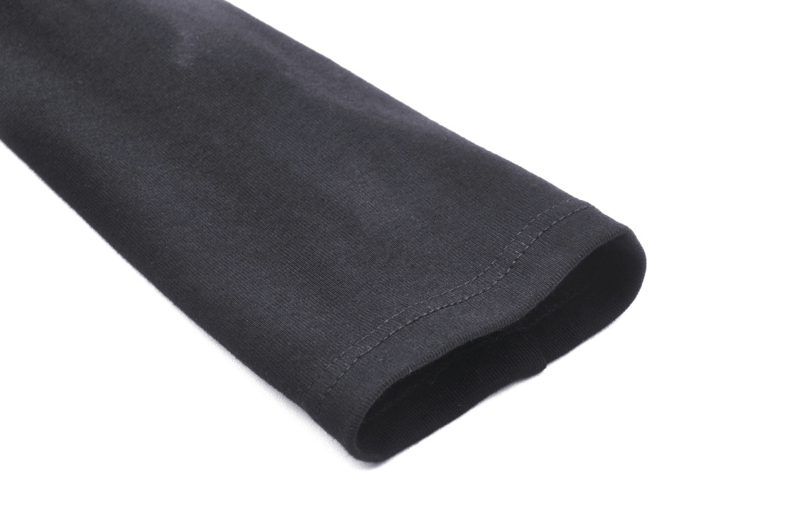 Close-up of the long sleeve of a sexy gothic off-shoulder top in black fabric, showcasing a stylish and versatile design.