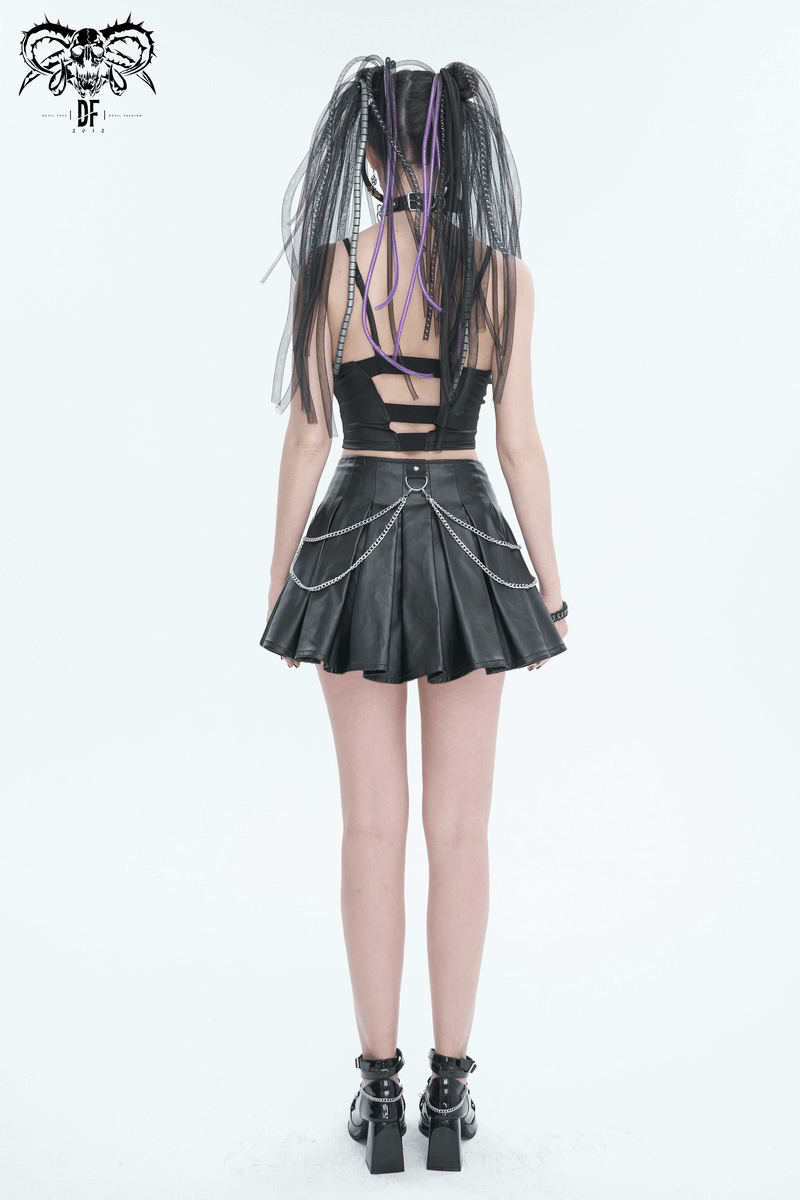 Back view of a woman in a black sexy grunge crop top and leather mini skirt with stylish chains and edgy hairstyle.