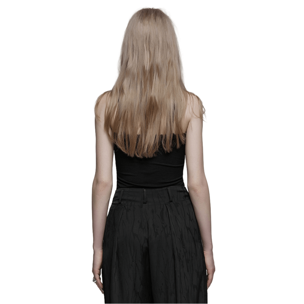Back view of a woman wearing a black halter camisole and stylish pants, showcasing a chic and edgy fashion look.