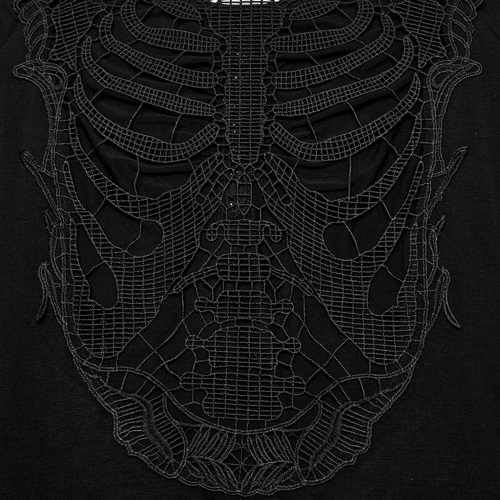 Intricate black lace design resembling a skeleton, showcased on a dark fabric background, adding a gothic touch.
