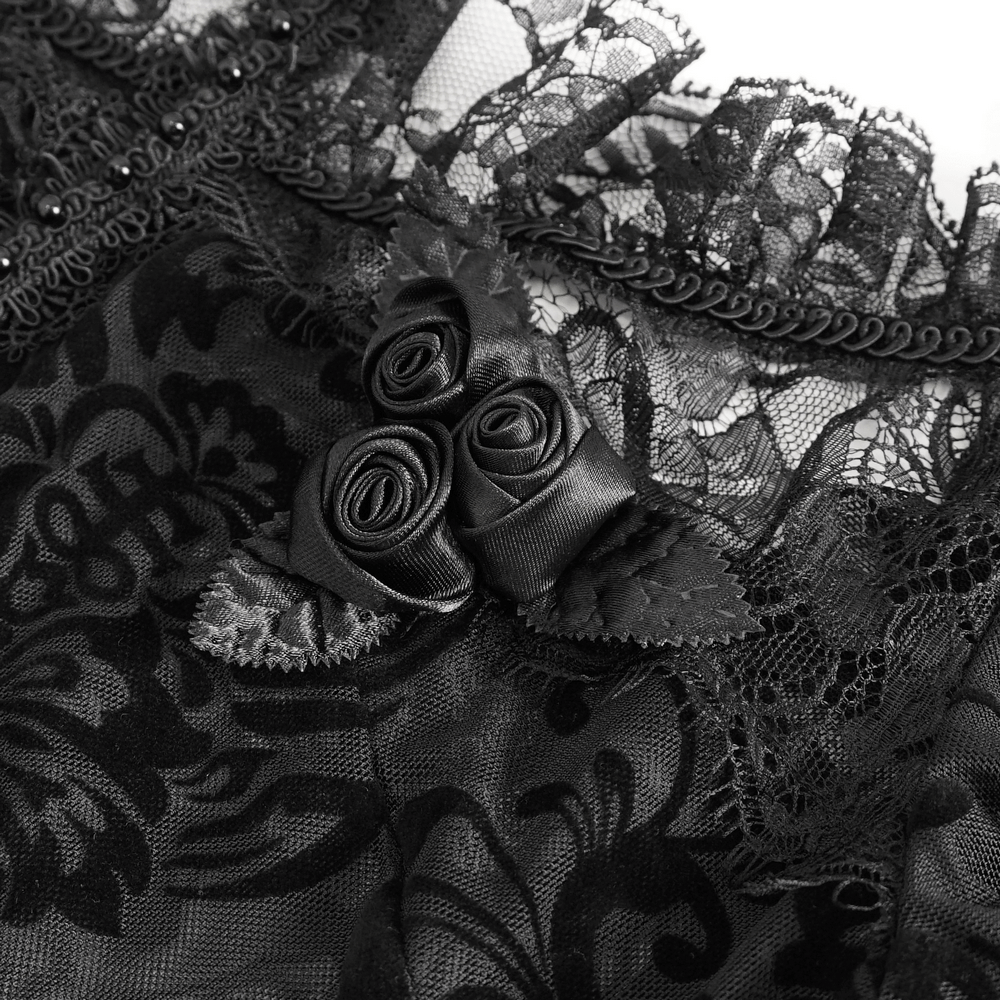 Elegant black lace blouse with intricate floral patterns and charming ribbon rose accent.