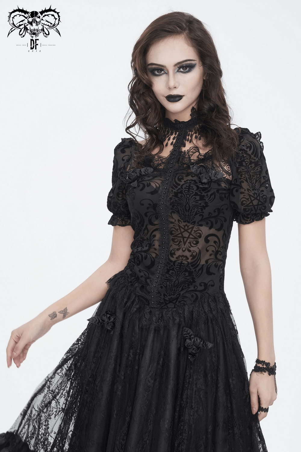 Chic black lace blouse with puff sleeves and intricate fringe detail, perfect for elegant day-to-night looks.