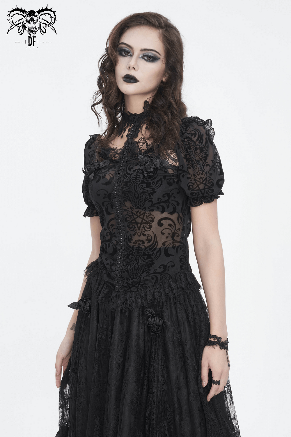 Chic black lace blouse with puff sleeves and intricate fringe detail, perfect for elegant day or night outfits.