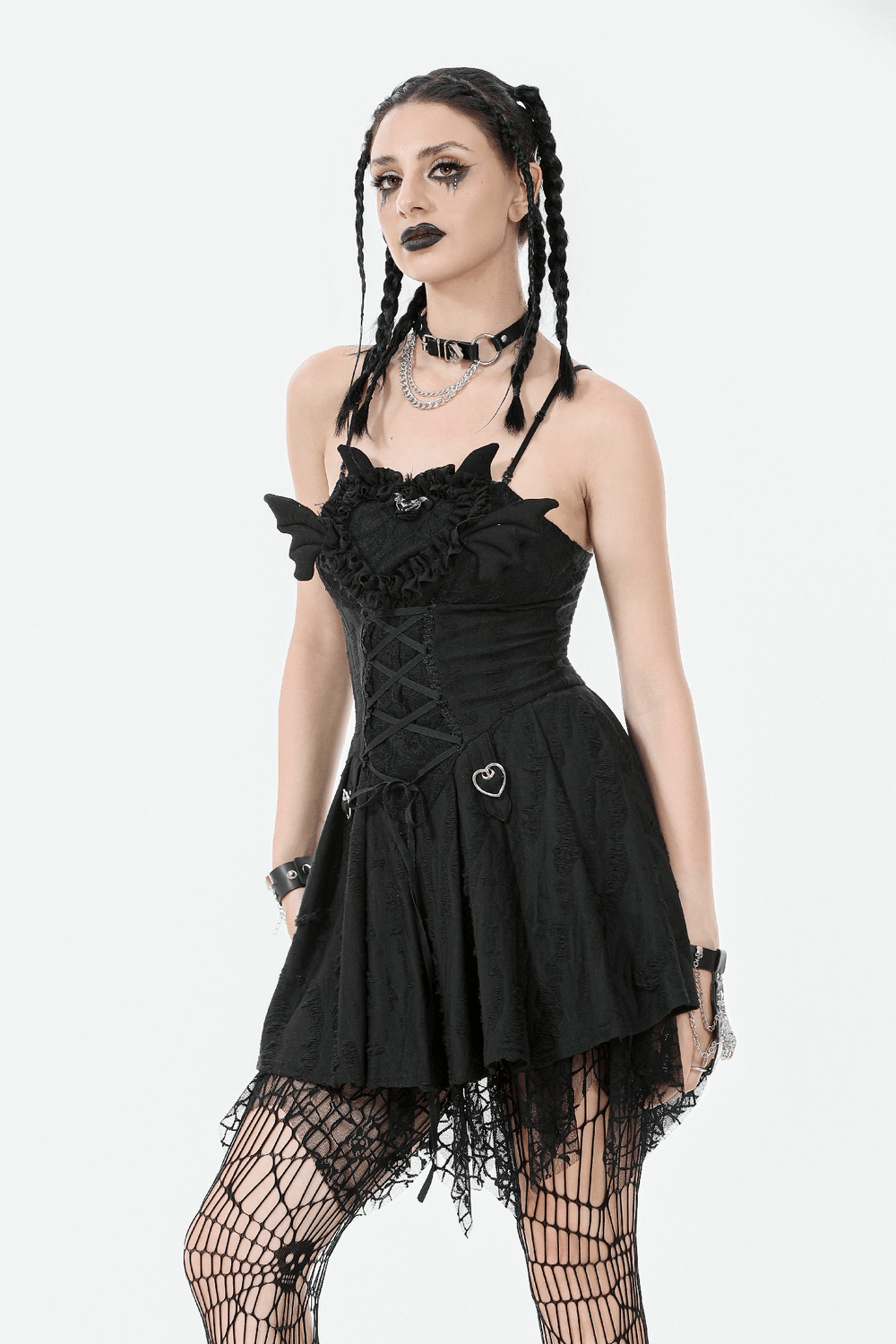 Model wearing a sexy lace corset dress with heart clips and a mesh hem, showcasing a bold gothic style.