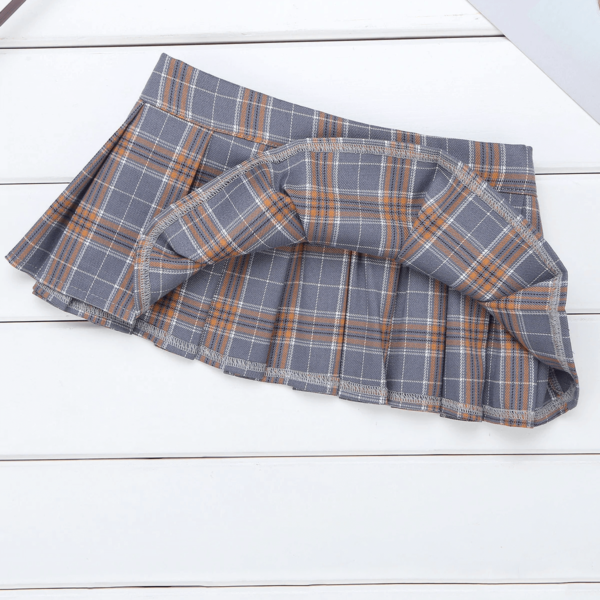 Cute gray pleated mini skirt in Scottish style with orange plaid pattern, perfect for punk fashion lovers.