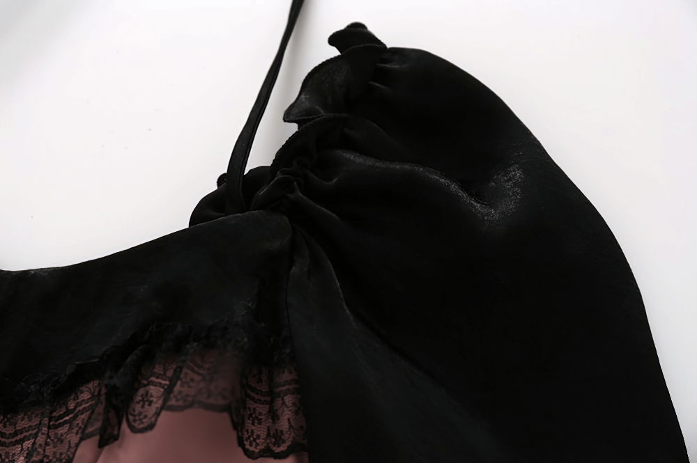 Close-up of the stylish black and pink halter dress showcasing elegant lace detailing and soft fabric.