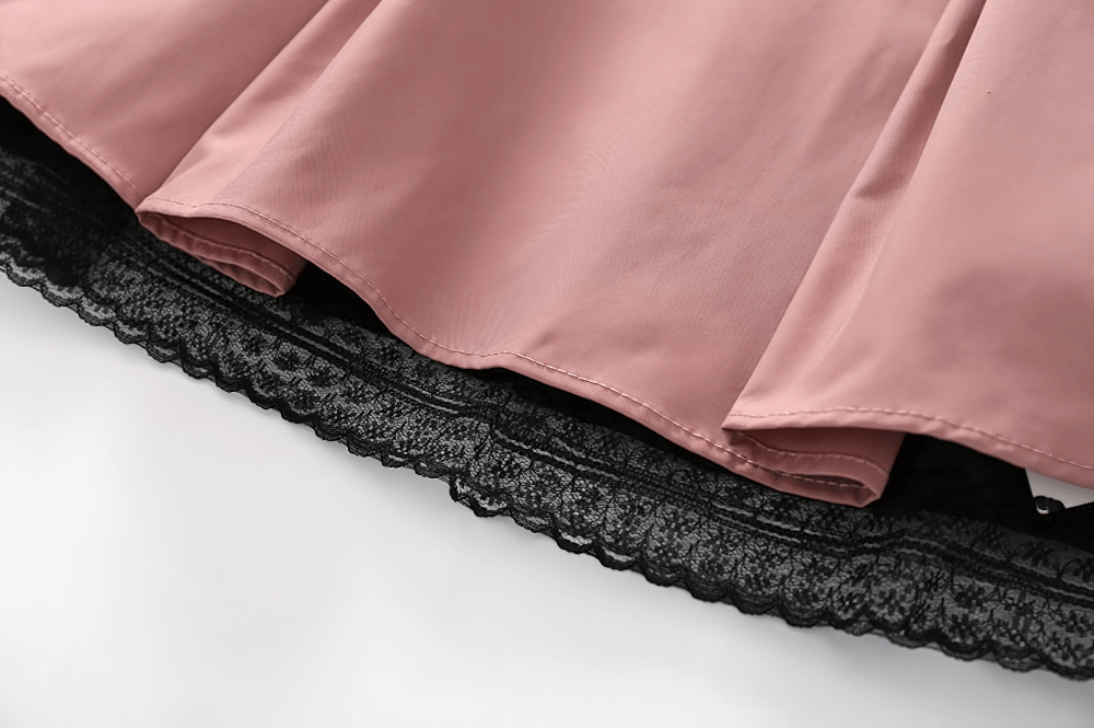 Close-up view of pink mesh dress hemline with black lace detailing, showcasing a gothic and sexy aesthetic.