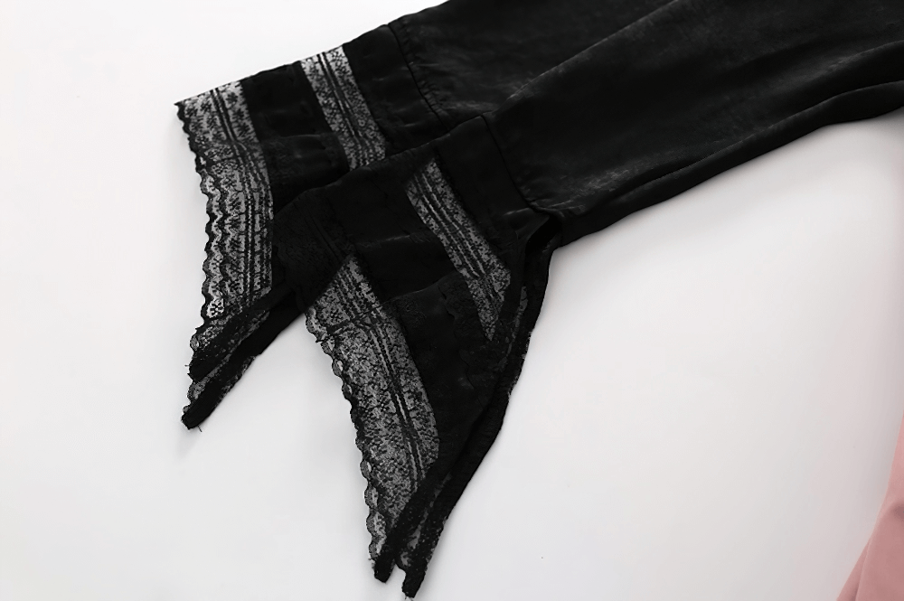 Close-up of black lace-trimmed long sleeves, highlighting gothic elegance and intricate detailing.