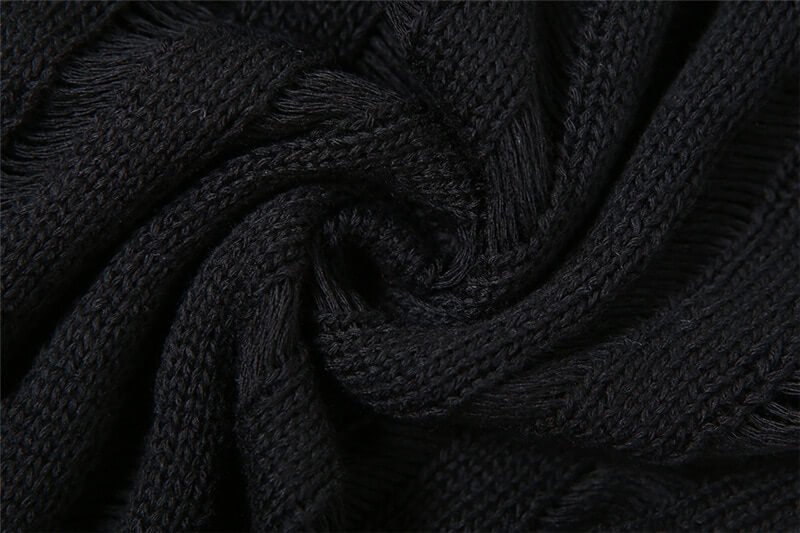 Close-up of soft black knit fabric, showcasing its texture for stylish women's tops and grunge fashion.