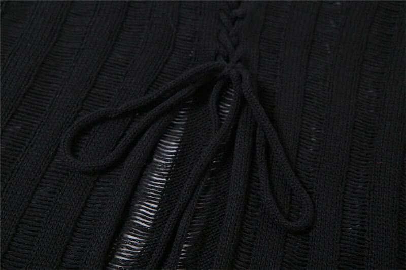 Close-up of lace-up detail on a sexy black knitwear women's top, blending grunge and glamour.