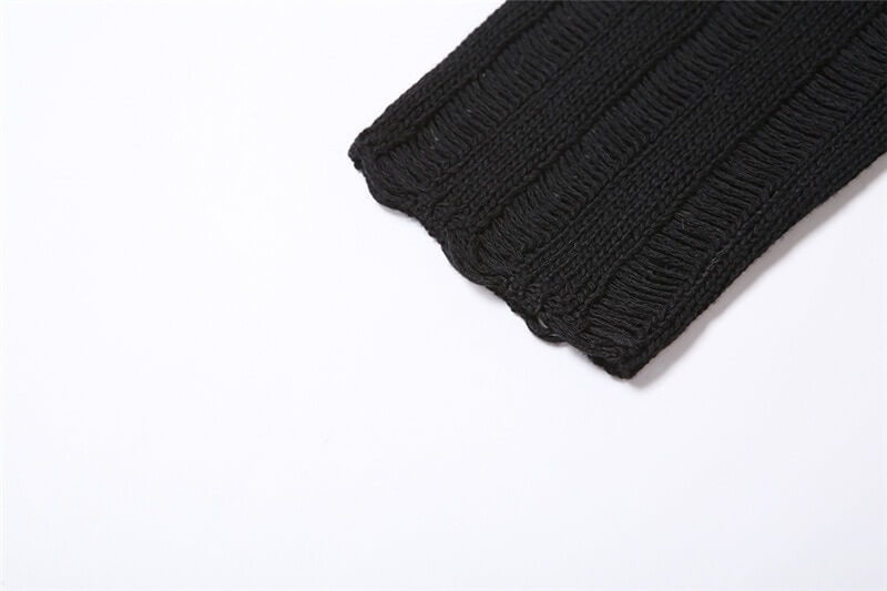 Close-up of the textured black knitwear sleeve featuring a scalloped edge, perfect for a chic grunge look.
