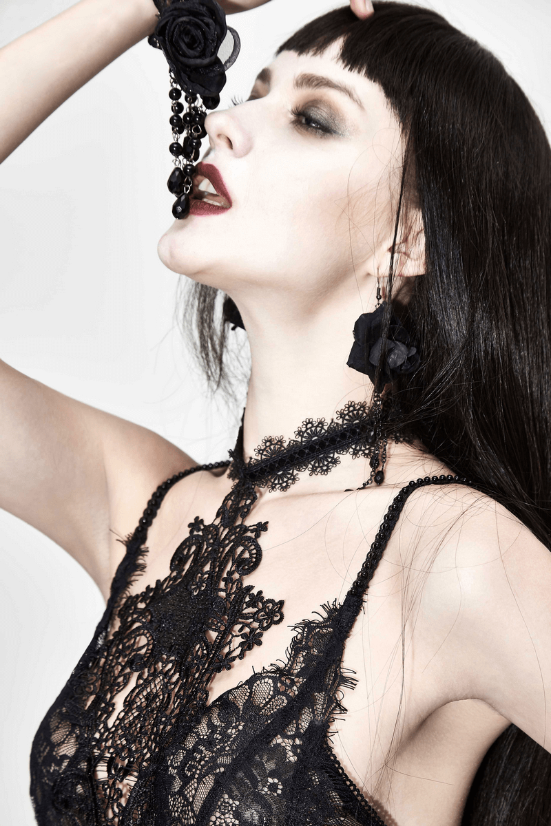 Gothic woman modeling a sexy long transparent black lace dress with intricate details and elegant accessories.