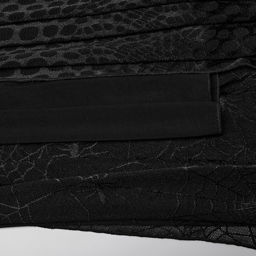 Close-up of black mesh fabric featuring spiderweb and python patterns for gothic dress.
