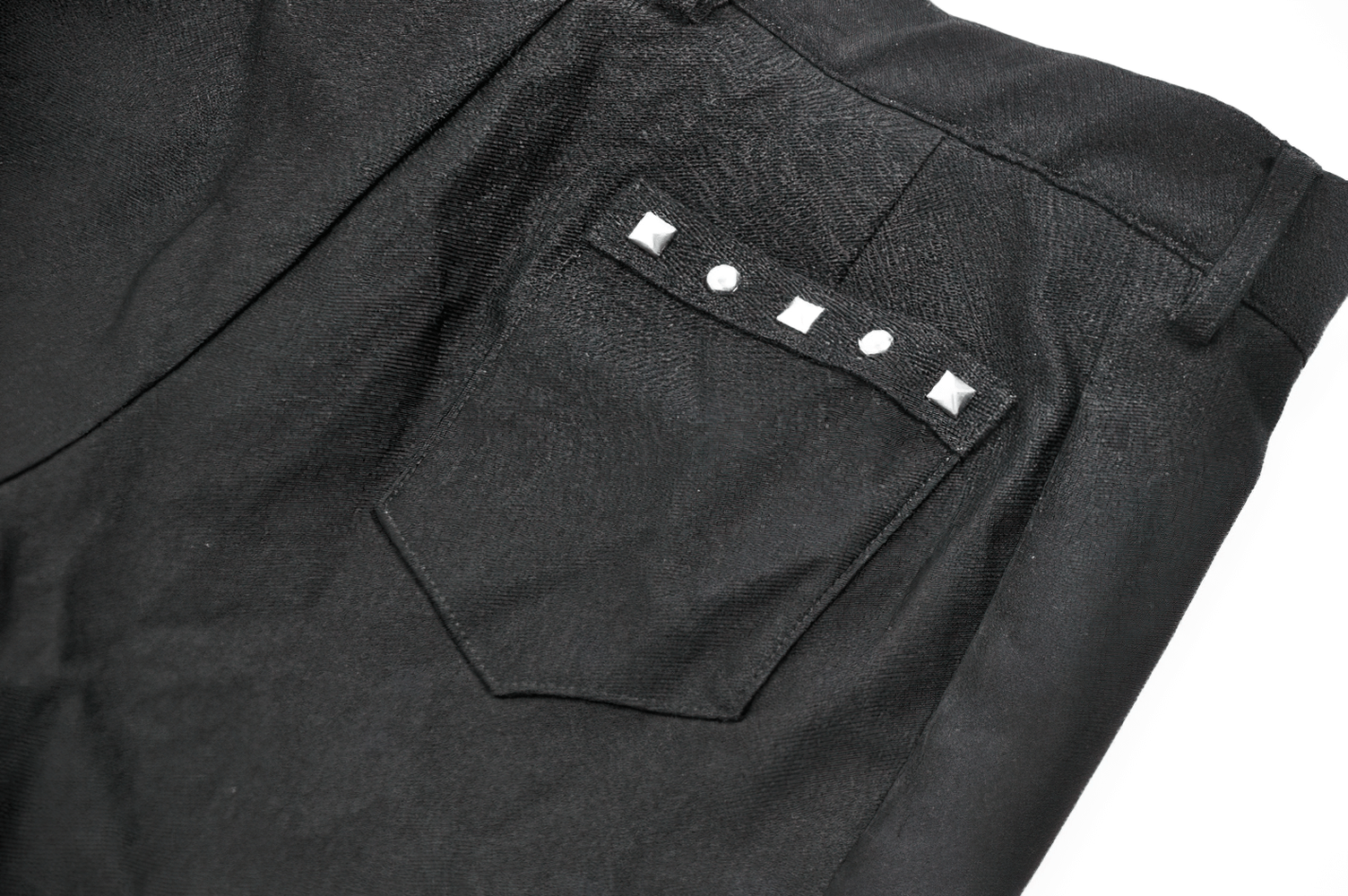 Close-up of black shorts back pocket with studded design for edgy punk style