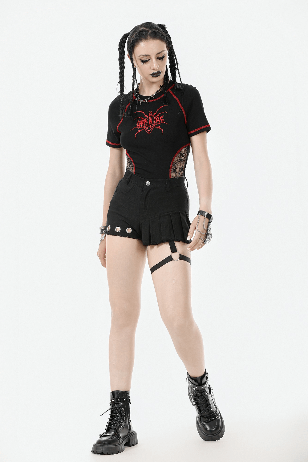 Gothic punk model in sexy pleated shorts with O-ring strap and eyelet detail, styled for alternative streetwear.