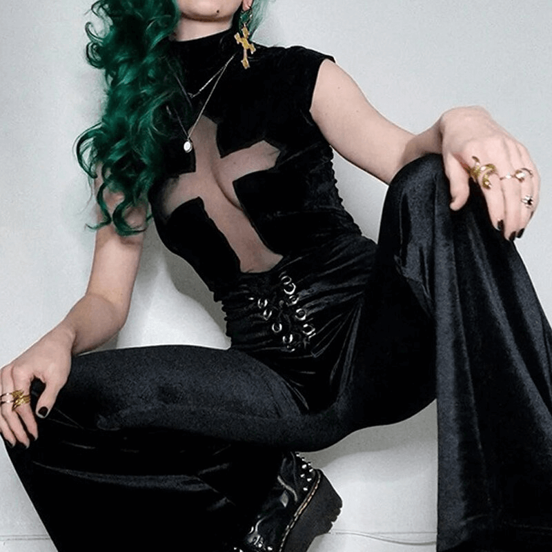 Edgy punk women's black T-shirt with sheer cross detail, styled with chic flair and black pants.