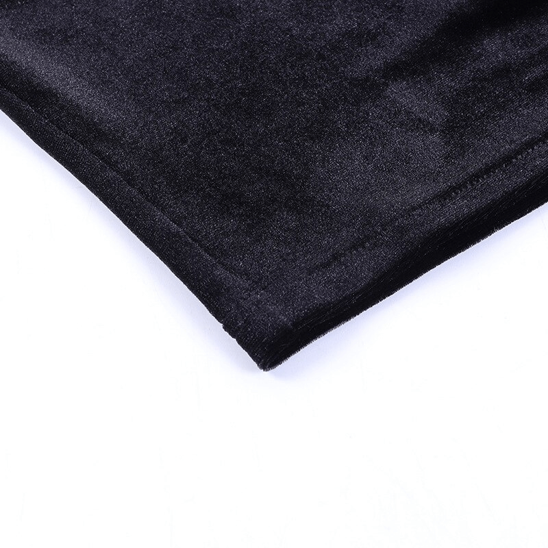 Close-up of the soft black fabric of a sexy punk women's T-shirt with sheer cross detail.