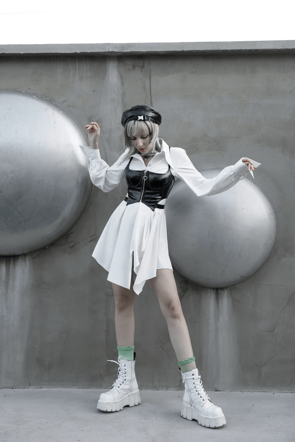 Model wearing a sexy punk rave black zipper crop camisole with a white dress and edgy accessories.