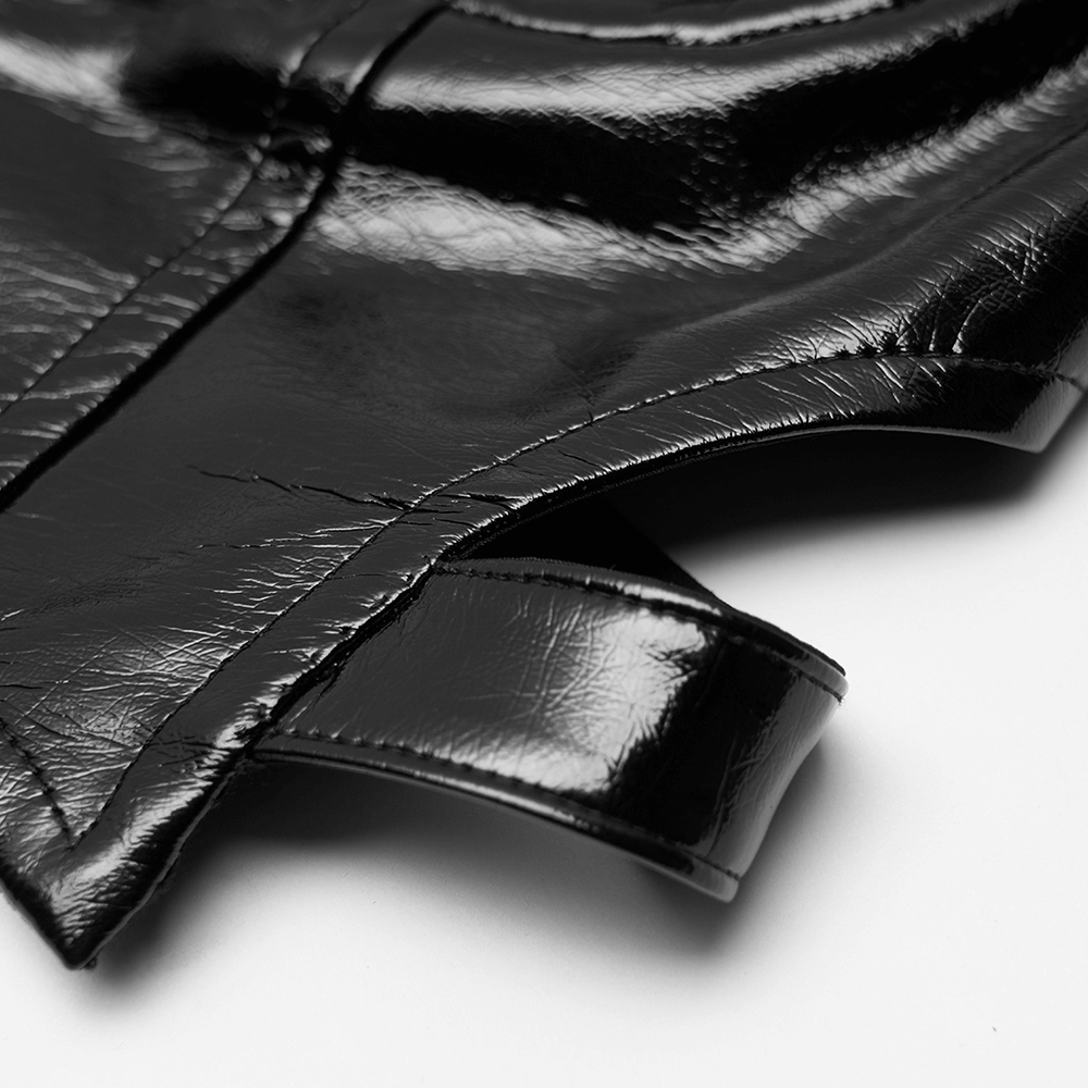 Close-up of black PU leather details from a punk rave-inspired crop camisole with glossy finish.
